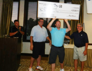 three guys with big check