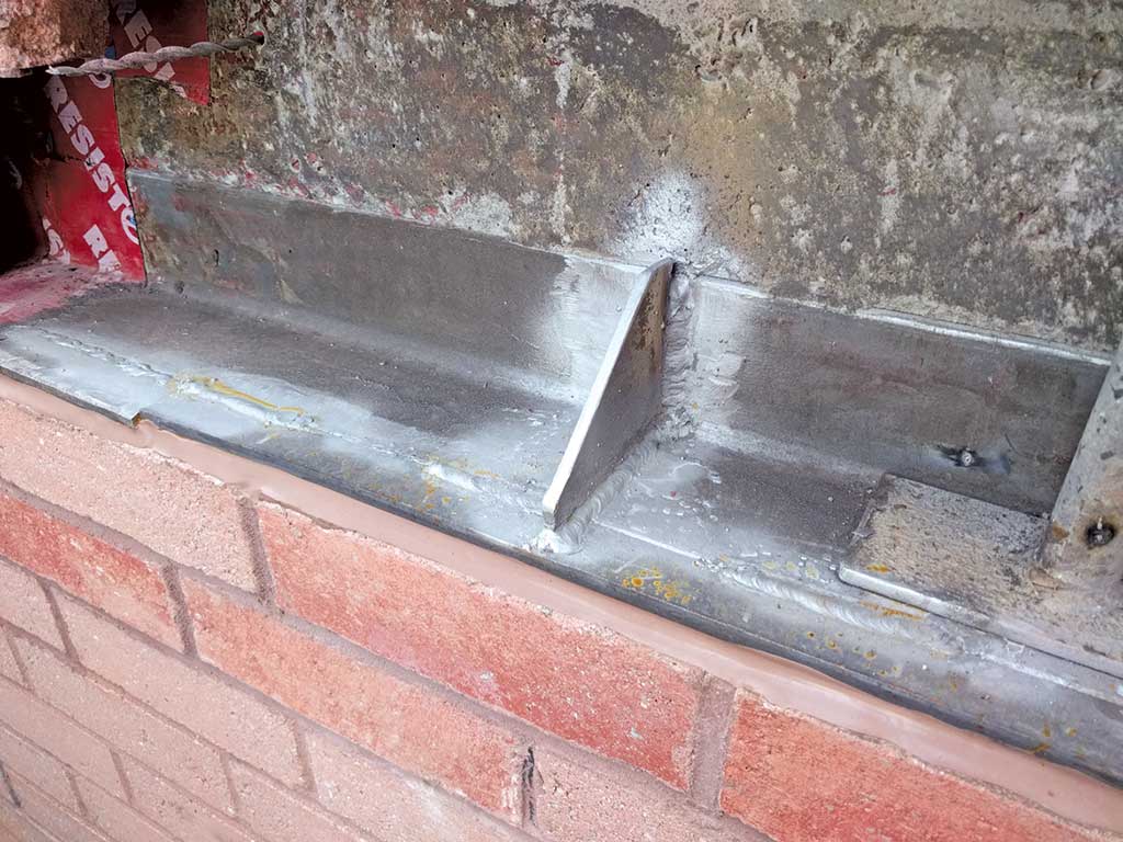 new metal shelf resting on bricks below