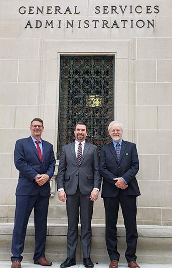 three guys in front of gsa building