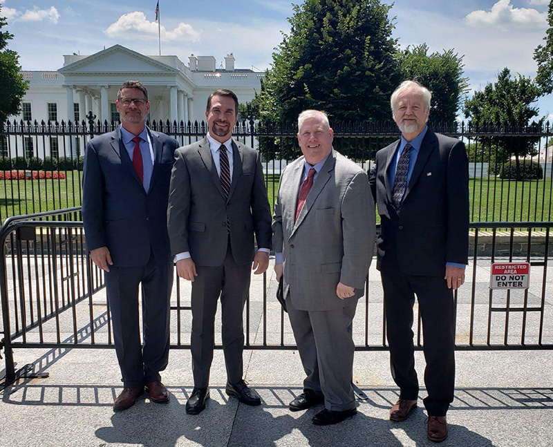 four guys in front of capitol building