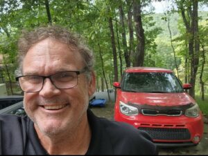 Rich Chapman with the red car he donated to the RCI-IIBEC Foundation's Cartober.