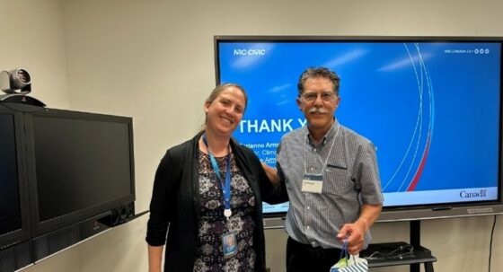 Phil Dregger, right, receives a token of appreciation from Marianne Amerston, director for climate adaptation program at the NRC.