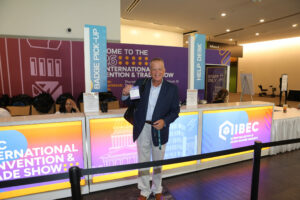 An attendee of the 2026 IIBEC International Convention and Trade Show displays his badge.