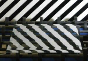 Close-up of bold black and white diagonal stripes creating a zigzag optical pattern on a screen or sheet.