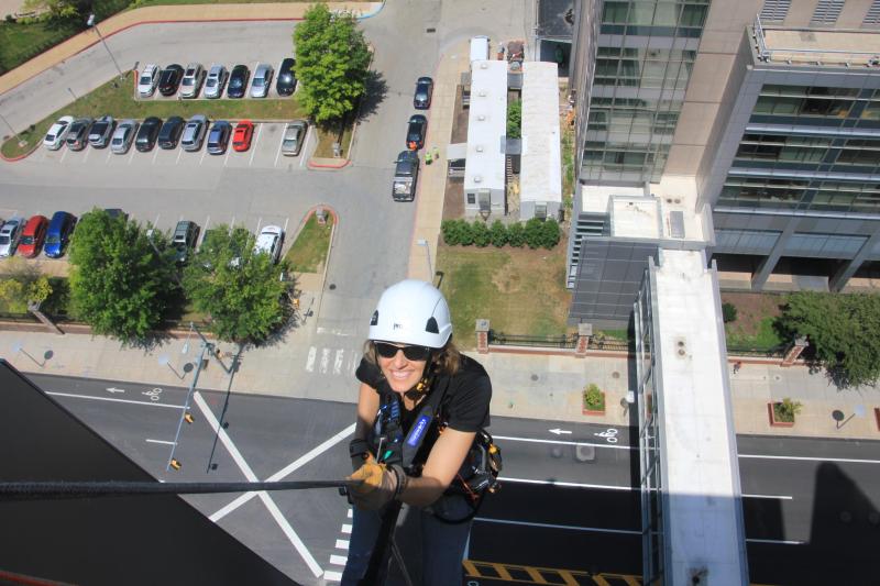 Keegan hanging from a building.